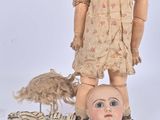 a doll and a doll head on a table
