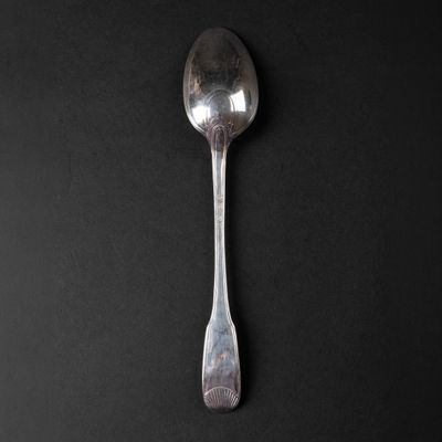 a spoon that is sitting on a black surface