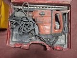 a red tool box with tools in it on the floor