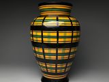 a vase that has a yellow and black design on it