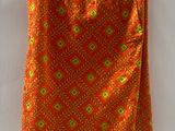 an orange skirt hanging on a hanger on a white wall