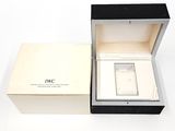 a box with a watch inside of it on a white surface