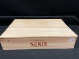 a wooden box with a name on it sitting on a table