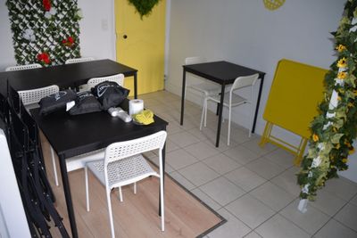 a table and chairs in a room with a yellow door