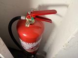 a fire extinguisor attached to a wall next to a door