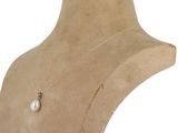 a close up of a mannequin with a pearl necklace on it