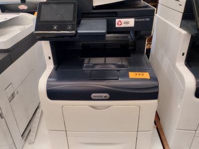 a printer that is sitting on the floor next to other printers