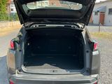 the back of a car with its trunk open in a parking lot