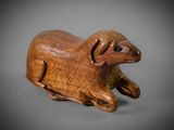 an image of a wooden animal figurine on a gray background