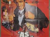 an old movie poster of a man in a tuxedo holding a gun