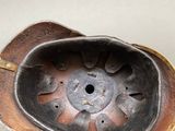 a metal bowl with holes in it on a table