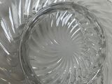 a glass bowl and a glass plate on a table