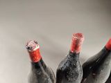 three bottles of wine that are sitting on a table