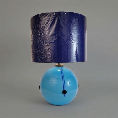 a blue lamp with a blue shade on top of it