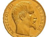a close up of a gold coin with a man ' s face on it