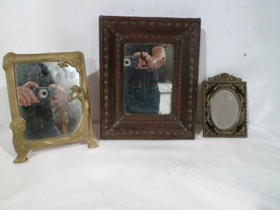 three pictures of a man taking a picture of himself in a mirror