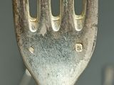 a fork that is sitting in front of a group of spoons