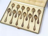 six spoons in a case that are sitting on a table