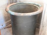 a large metal pot sitting in the corner of a room