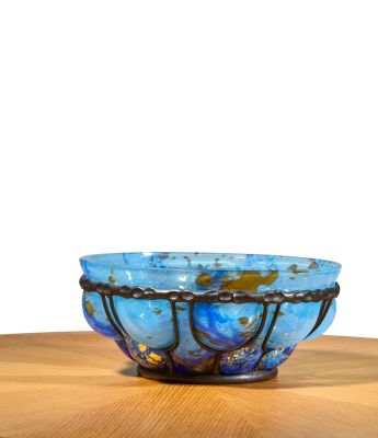 a blue bowl sitting on top of a wooden table