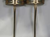a pair of black and gold side tables