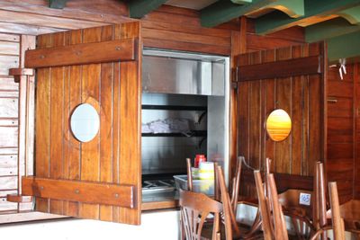 une table et des chaises en bois devant une porte ouverte