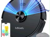 un gros plan d'un aspirateur robot avec un téléphone à côté