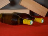 two bottles of wine sitting next to each other on a table