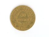 a gold coin on a white surface with a white background