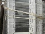 a picture of a stack of old windows in a junkyard