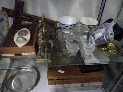 a glass table with a silver tray and a silver plate on it