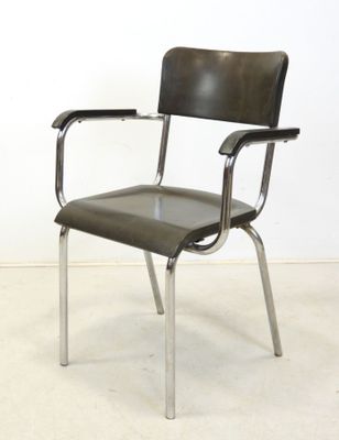 an image of a black leather chair with chrome legs