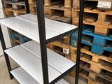 two shelves with white shelves in a warehouse filled with pallets