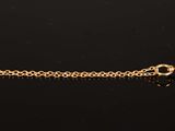 an image of a close up of a clock on a chain on a table