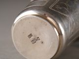a close up of a silver cup on a table
