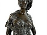 bronze statue of a woman in a corset dress