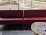 two red couches sitting next to each other in a room