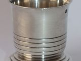 a silver cup that is sitting on a table