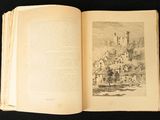 an open book with a drawing of a castle in the background
