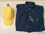 polo shirt and hat sitting on top of a table next to a hat