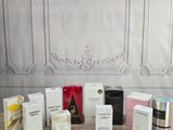 various types of perfumes and boxes on a table