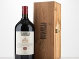 the bottle of red wine is next to a wooden box