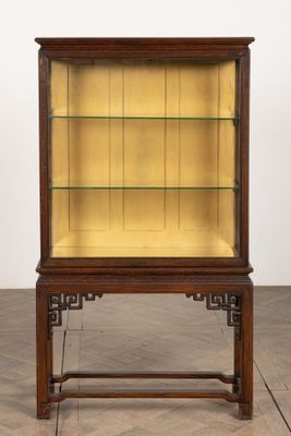 a wooden display case with glass shelves on top of it