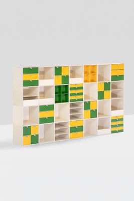 a white shelf with yellow and green squares on it