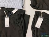two pairs of pants with tags on them on a table