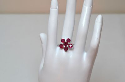 a white hand with a red ring on it