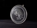 an image of a silver coin with a picture of a monkey on it
