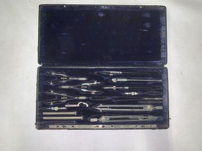 une mallette noire contenant des outils, posée sur une surface blanche