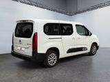 the white van is parked in the large room of the building