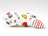 a white toy with a pattern on it on a white surface